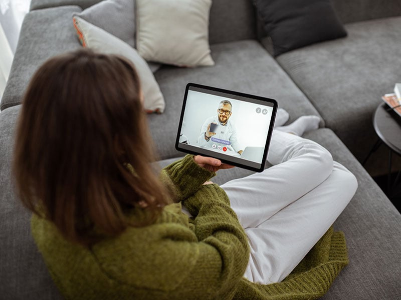 Woman-talking-with-a-doctor-online-using-digital-tablet